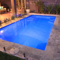 "Provincial" medium inground fibreglass swimming pool design, pictured in backyard