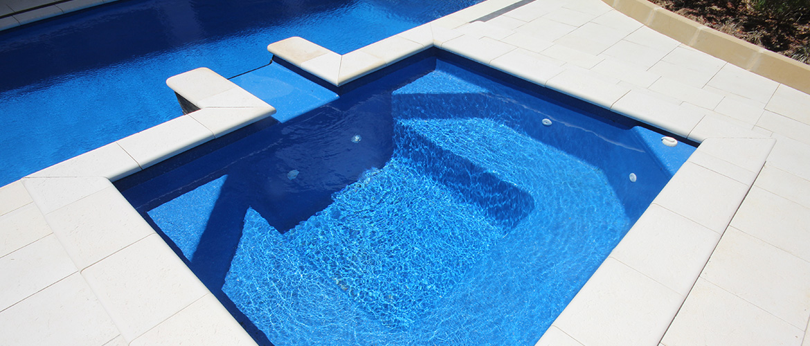 "Vail" Fibreglass Pool Spa Design, pictured as backyard pool spa, in "Assana Blue" pool colour